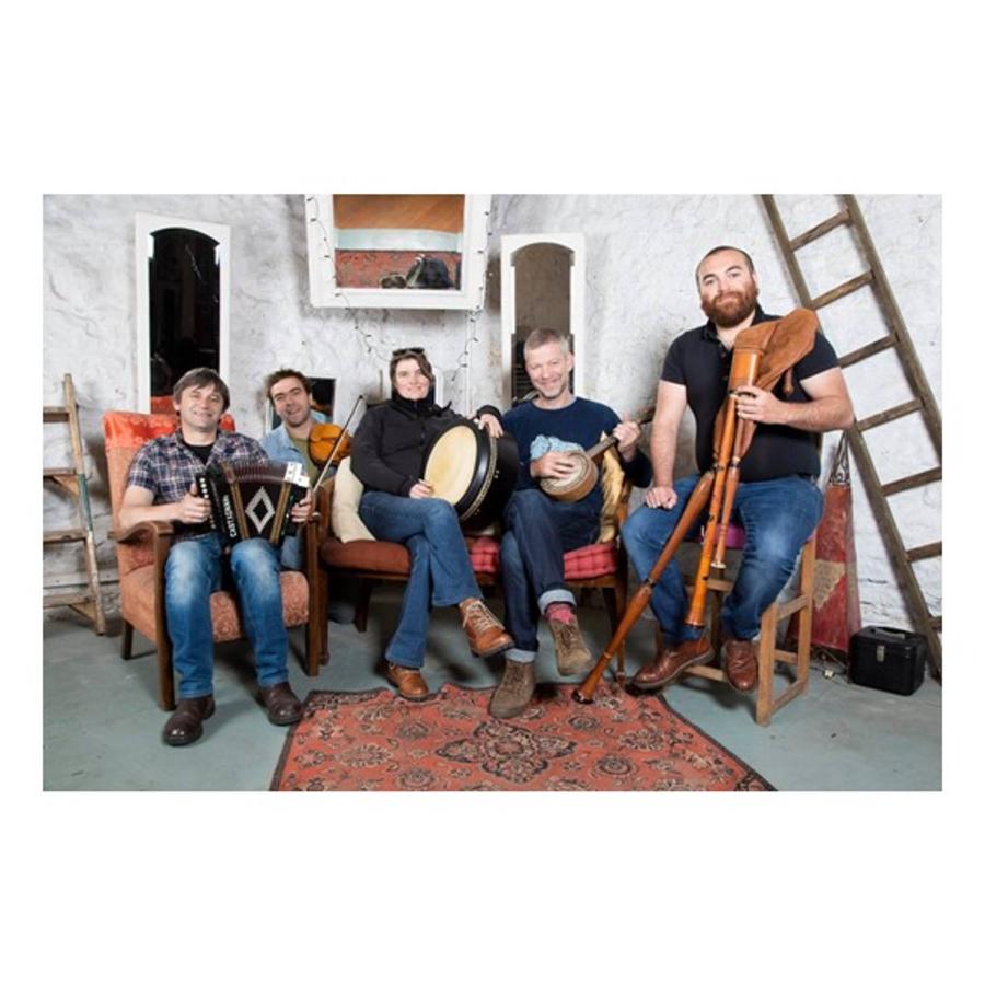 Men with various instruments posing for the camera