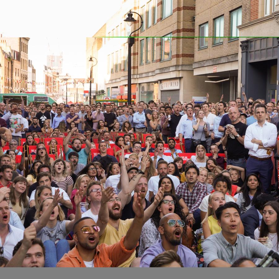 crowd of people watching open air cinema in Lower Marsh