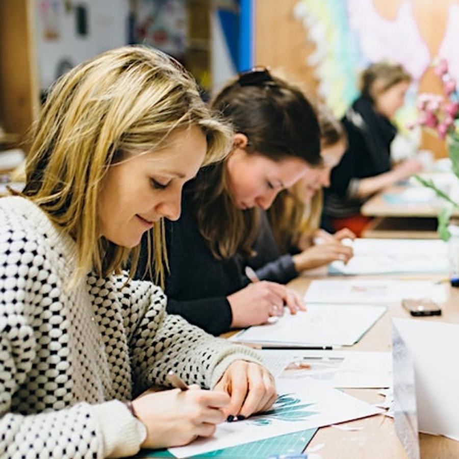 a group of students learning to papercut at an art workshop