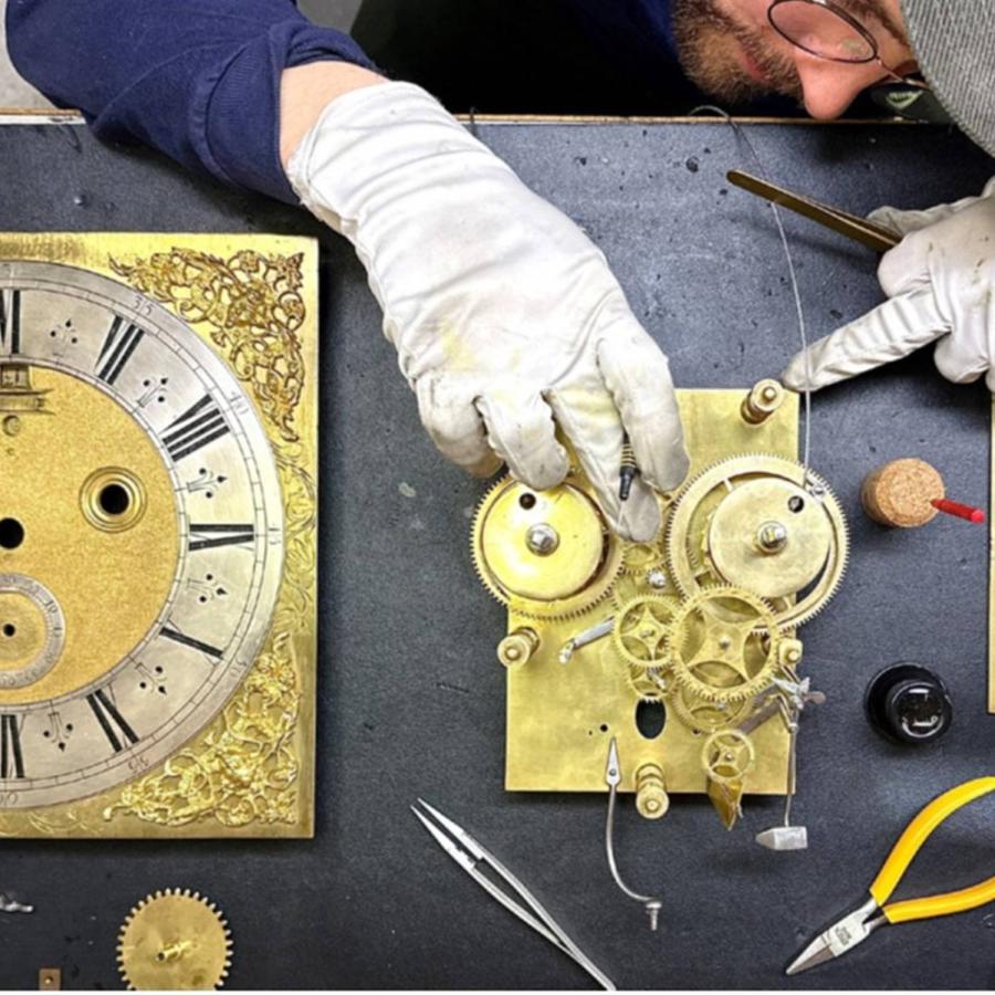 man repairing a clock
