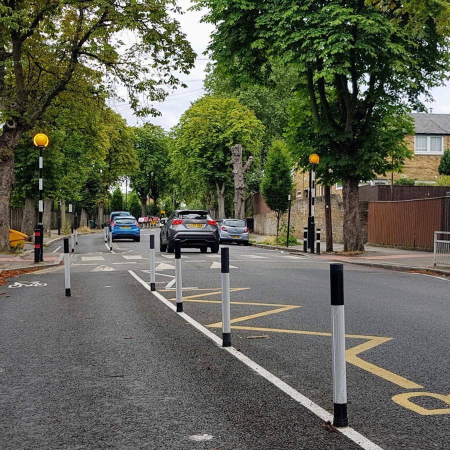 Street road with trees, road signs and cars