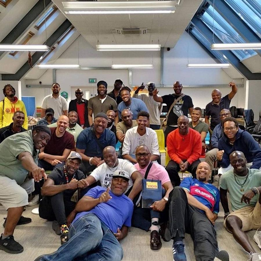 a group of men lying on the floor posing for the camera