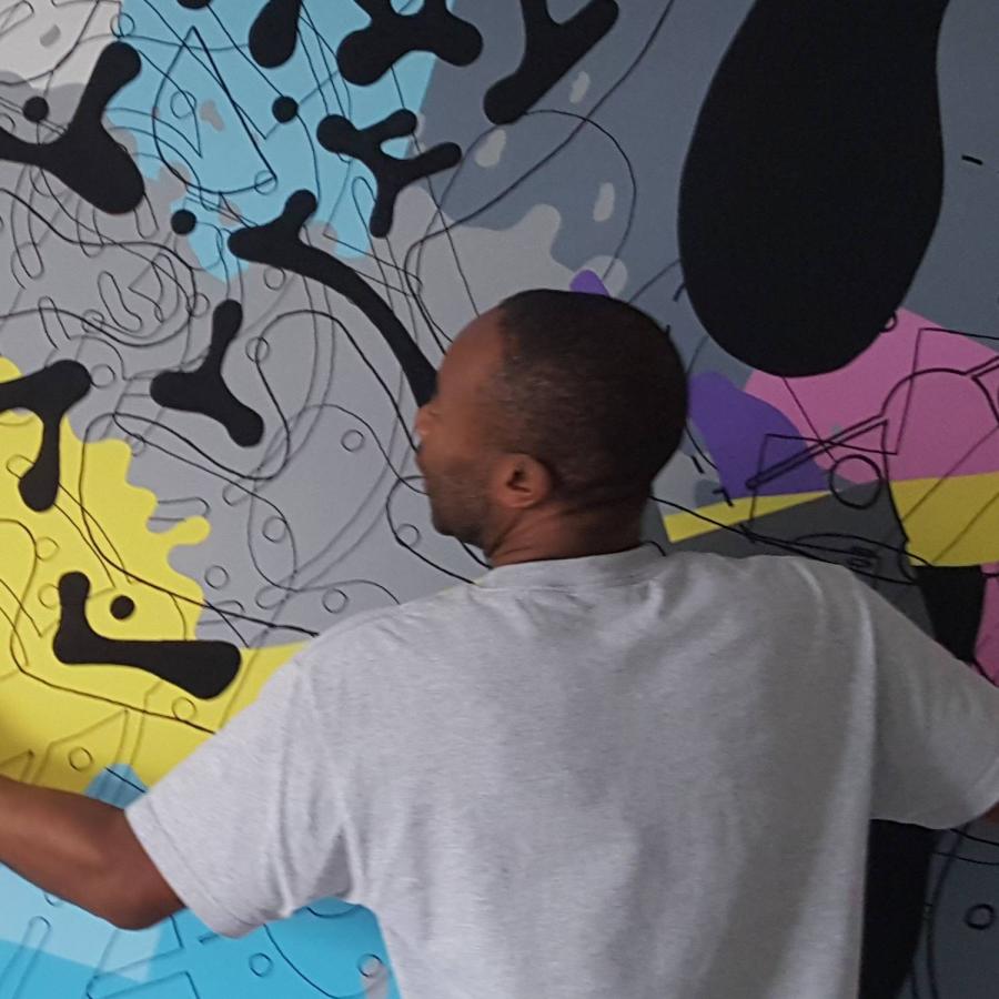a man hanging a display on the wall