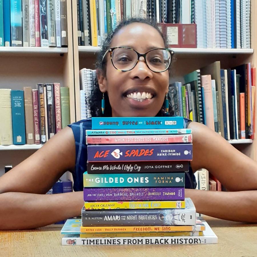 librarian surrounded by children story books