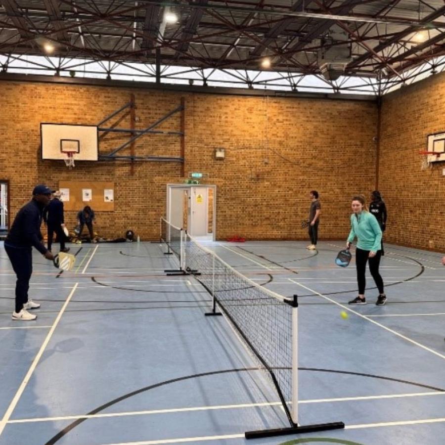 People playing Pickleball in a sports centre