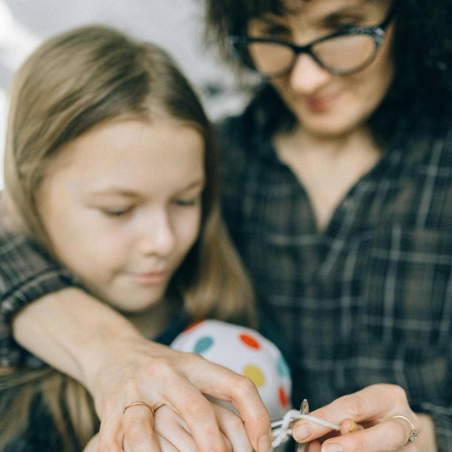 mother teaching her daughter to knit