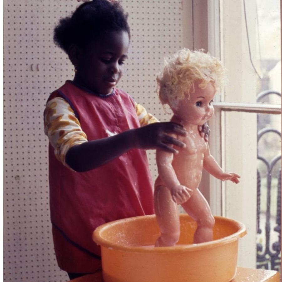 photo of child washing a doll by Frank Manning for the Children's society