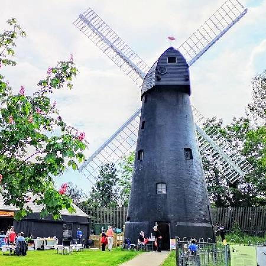 People gathered around the windmill