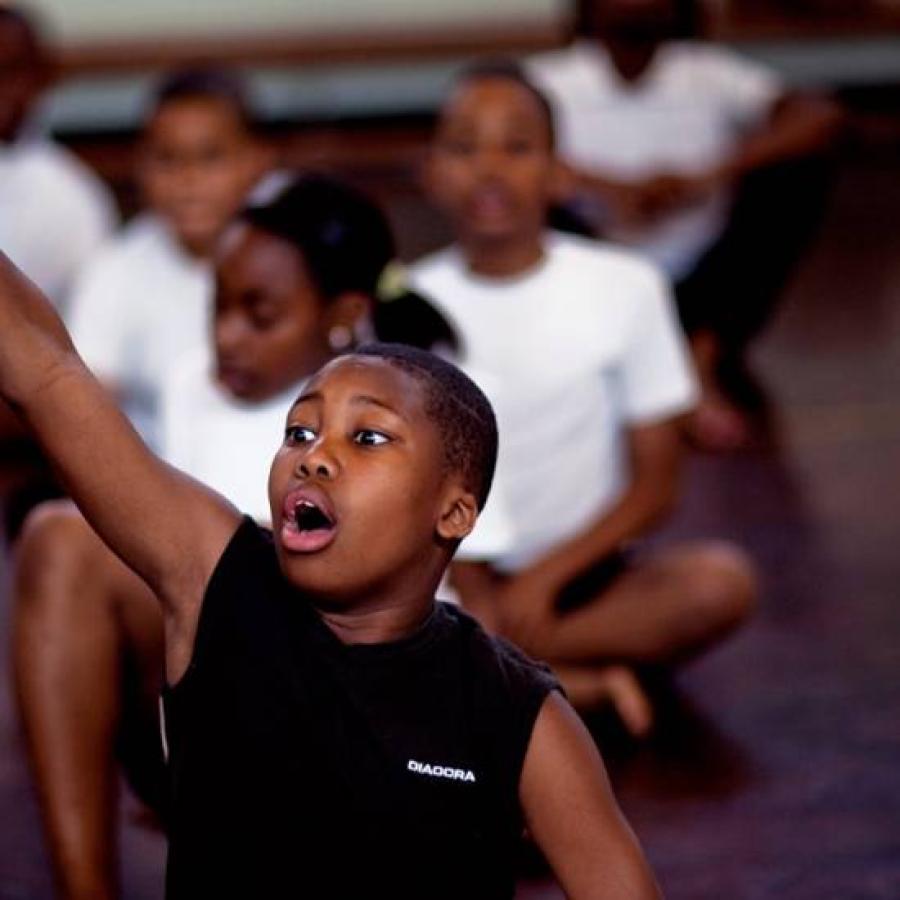 Pupils raising their hands to respond to questions