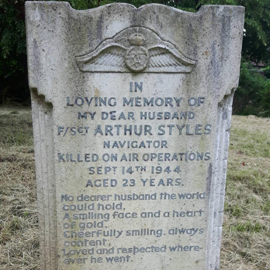 Headstone commemorating young wartime airman, lovingly remembered by grieving wife forever.
