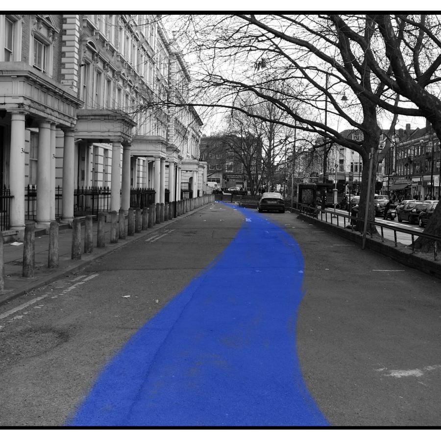 Black-and-white street scene featuring blue-highlighted pathway, trees, buildings, and parked cars.