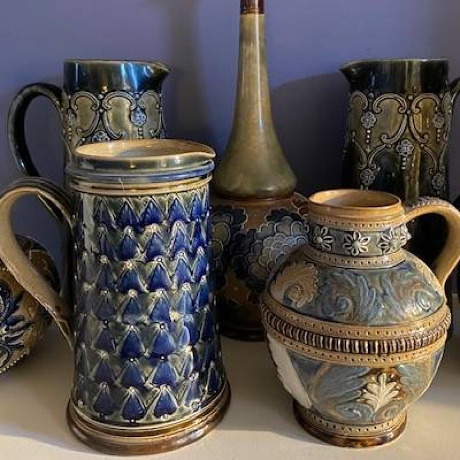 Blue and brown ceramic pottery collection featuring ornate handcrafted decorative vessels.
