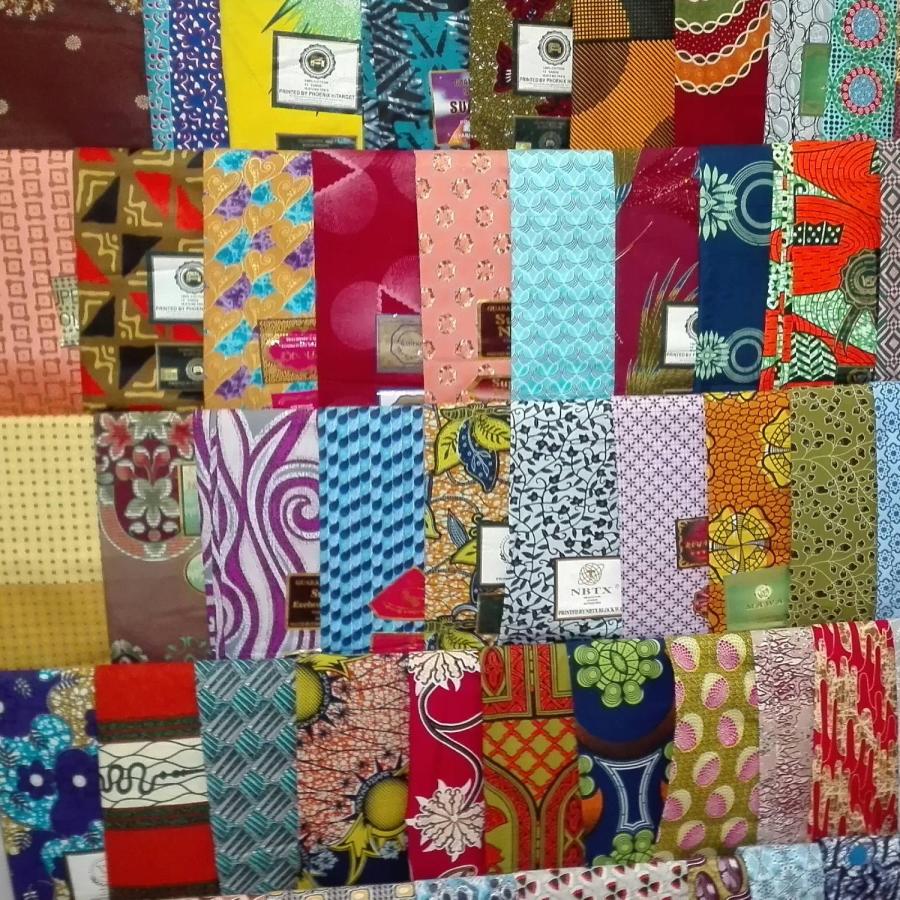 Various colourful clothes displayed neatly on a clothing rack.