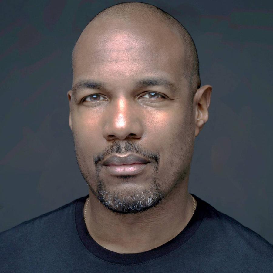 a man posing and smiling at the camera